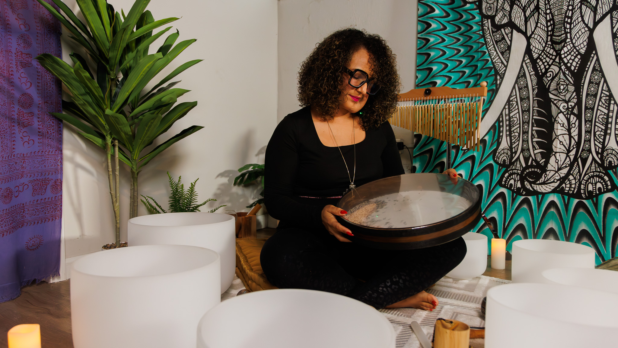 Dr. Sharon GE Washington using an ocean drum during a Guided Grounding sound immersion